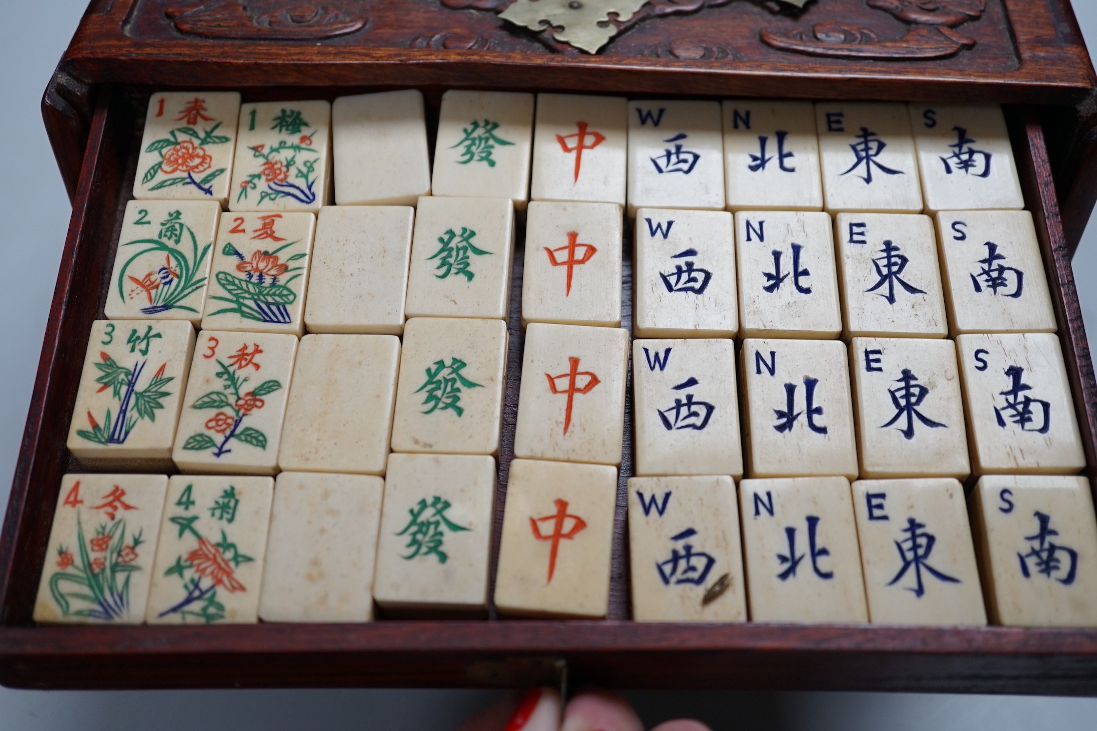 A Chinese Mah-Jong set in hardwood case with bone pieces